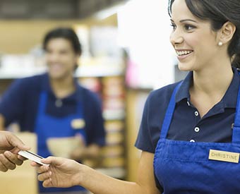 Store Clerk Accepting Credit Card Payment