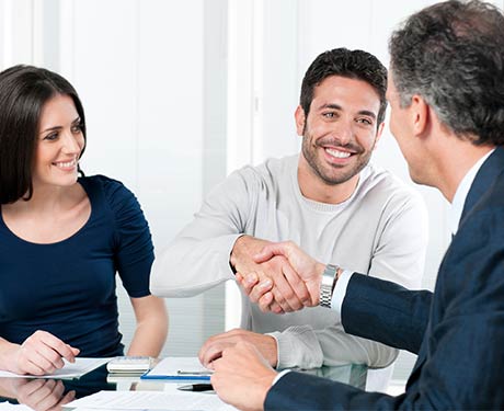 Happy Couple Reaching an Agreement with Businessman Happy Couple Reaching an Agreement with Businessman